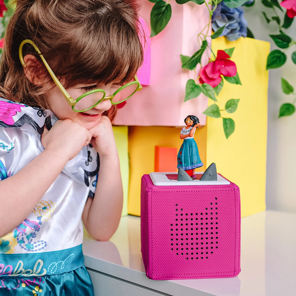 Child looking at Disney Encanto Tonie on Pink Tonie Box