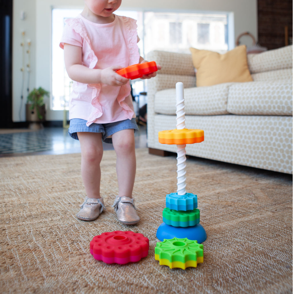 Girl Playing With Spin Again Ring Stacker 