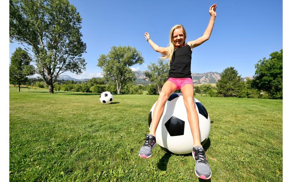 Child sitting on Jumbo Soccer Bounce Ball