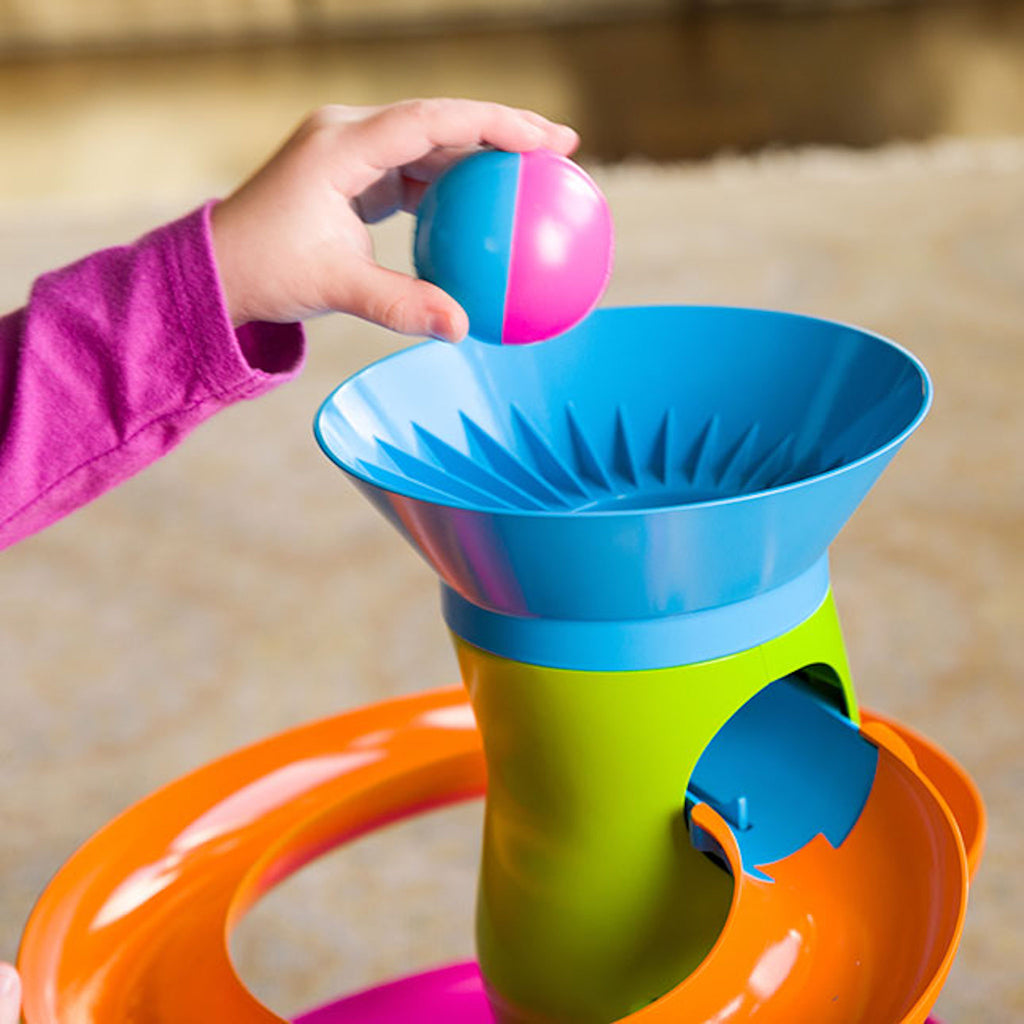 Child putting ball in Roll Again Tower