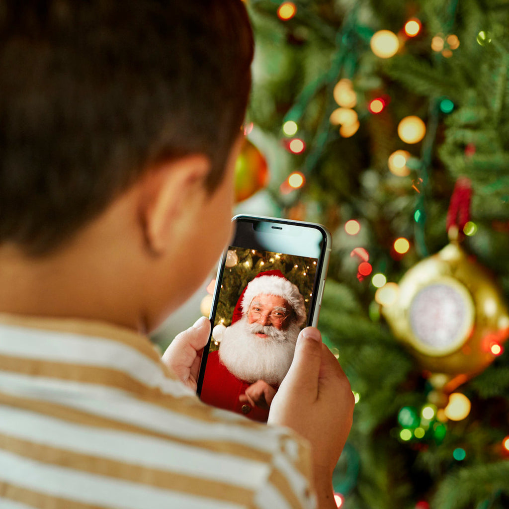 Child looking at Santa on Phone 