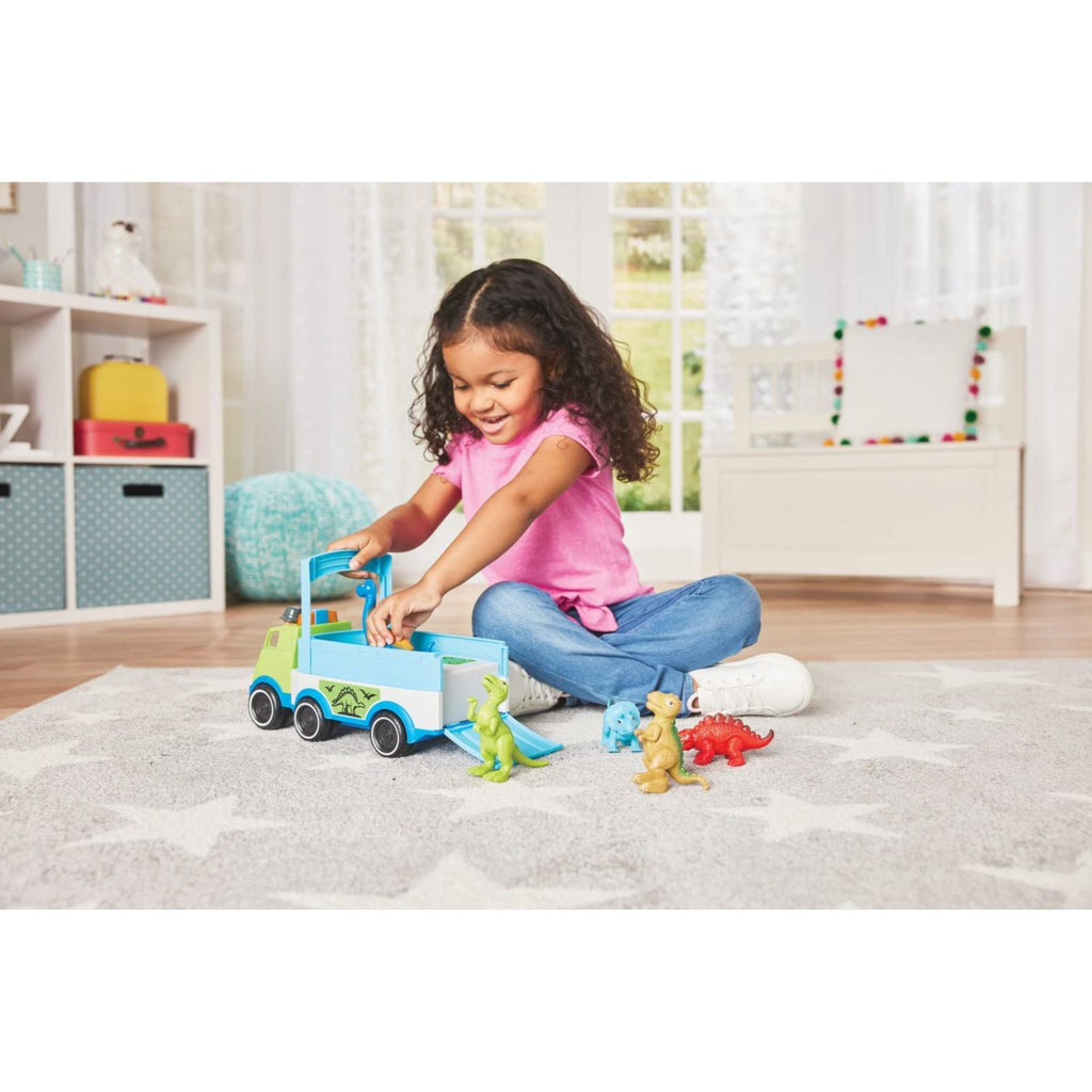 Child playing with Dino Adventure Hauler on floor