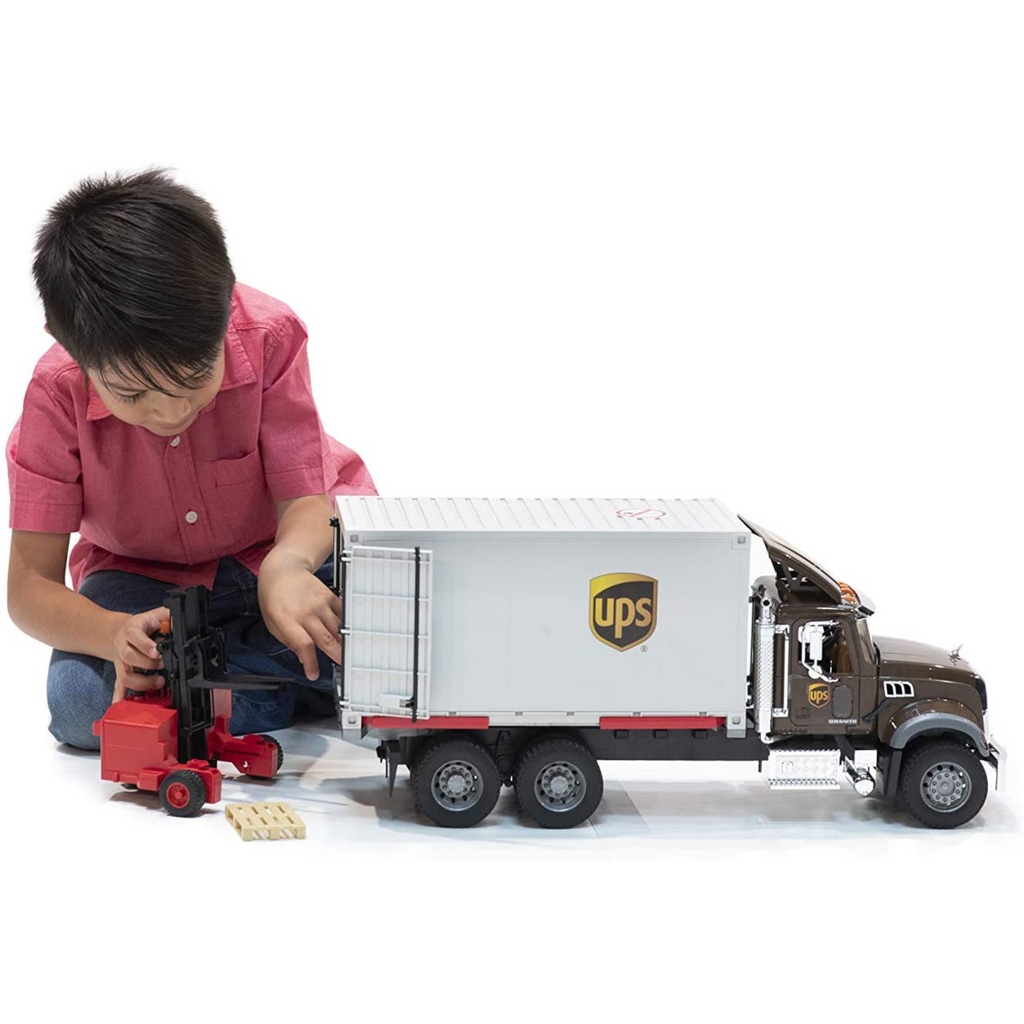 Child Playing Bruder Mack Granite UPS Truck 