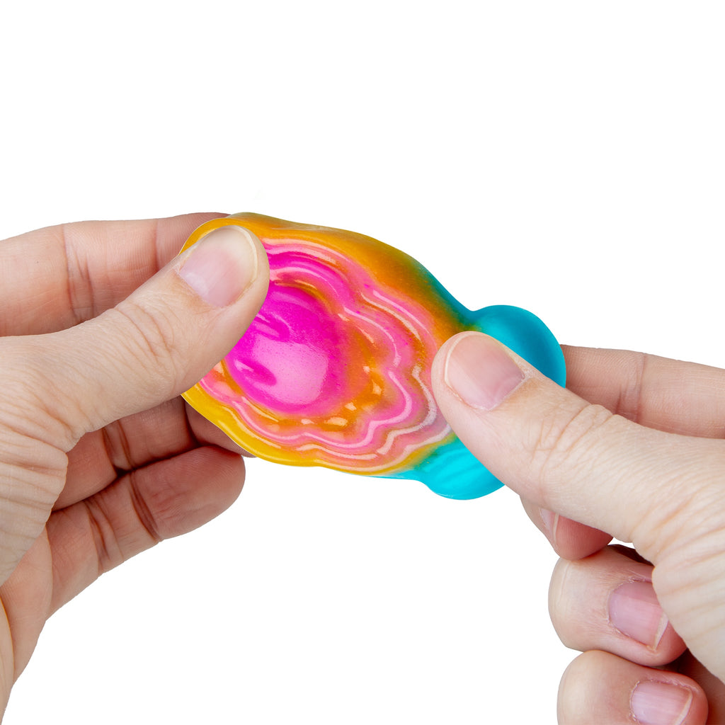 Hand stretching colorful taba squishy on a white background