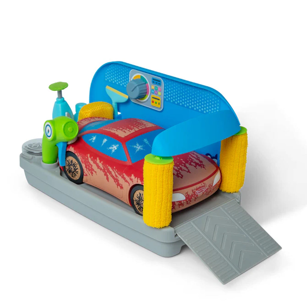 Toy car wash with 'dirt' on the red car, on a white background