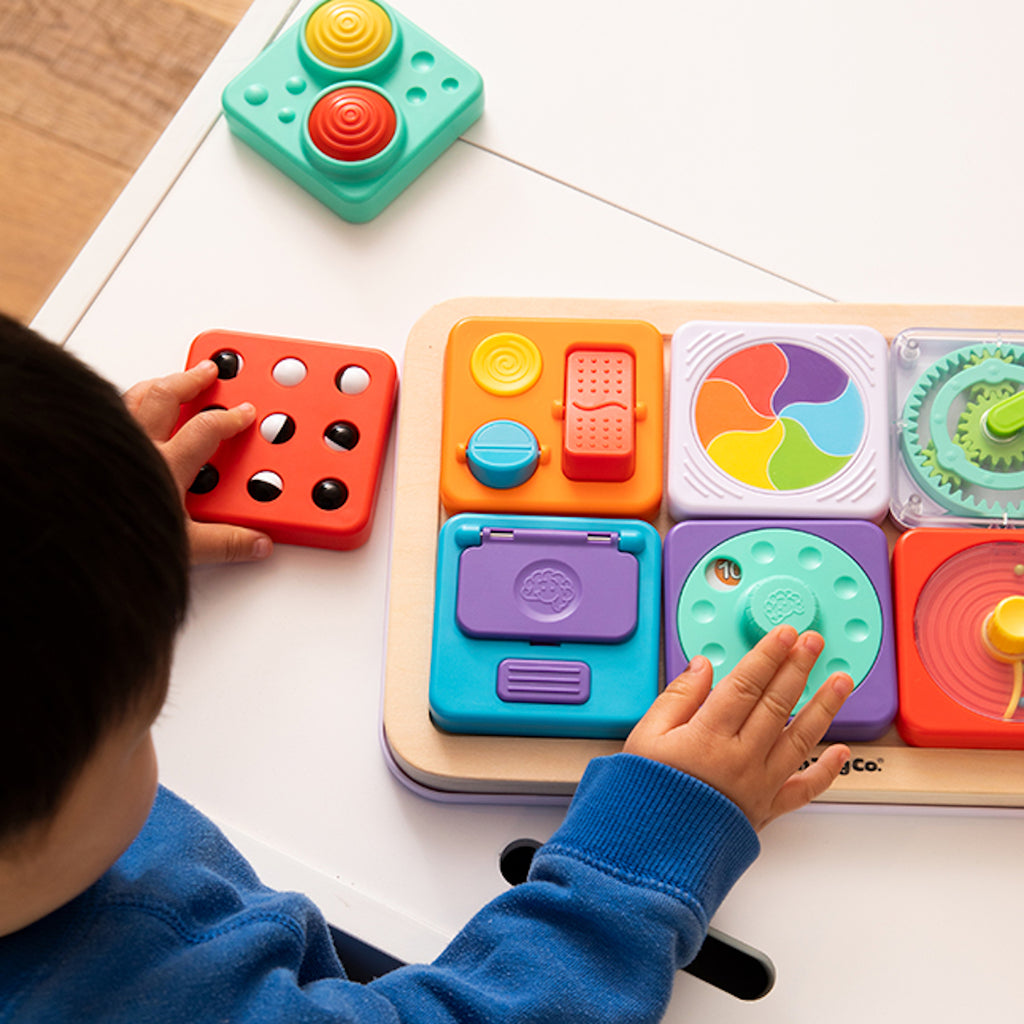 Child playing with PlayTab activity board