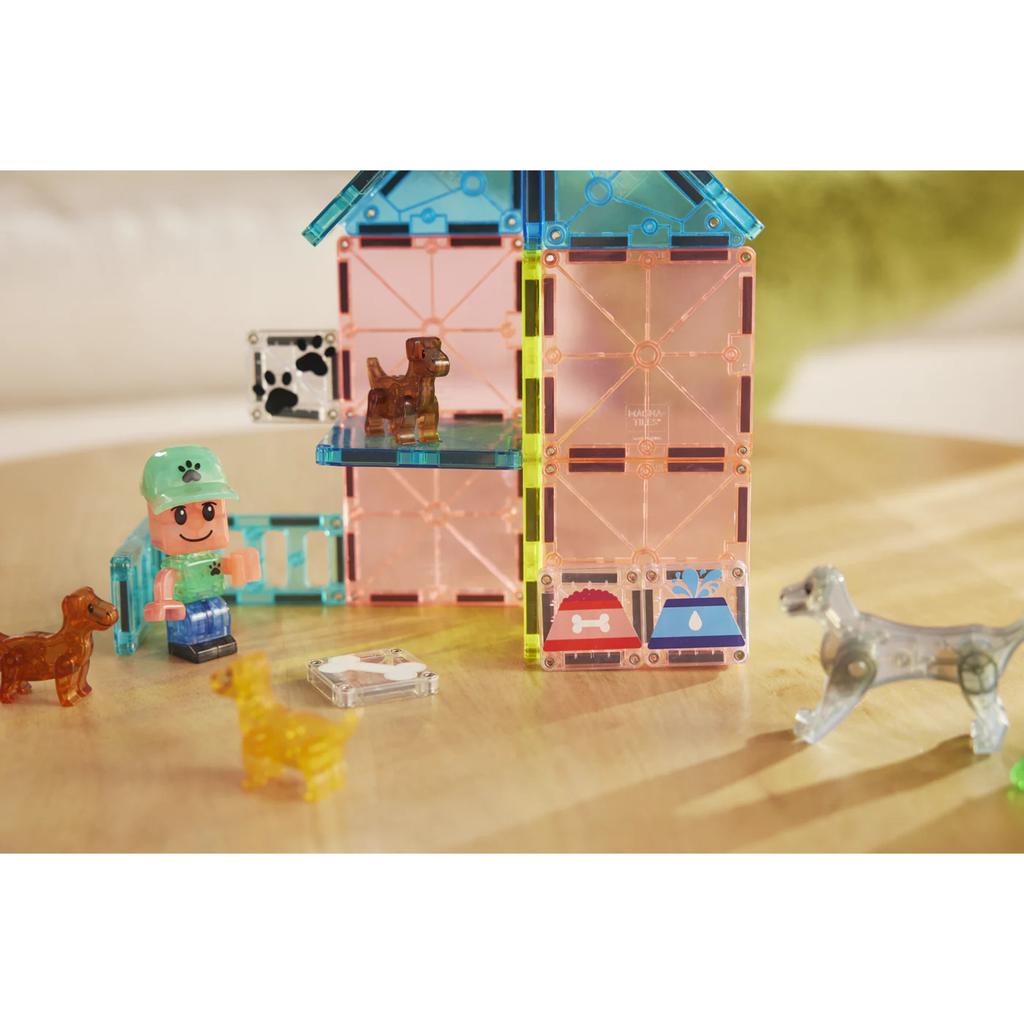 Magna-tiles Puppy Park Set with a house, person and dog figures on a wooden surface.