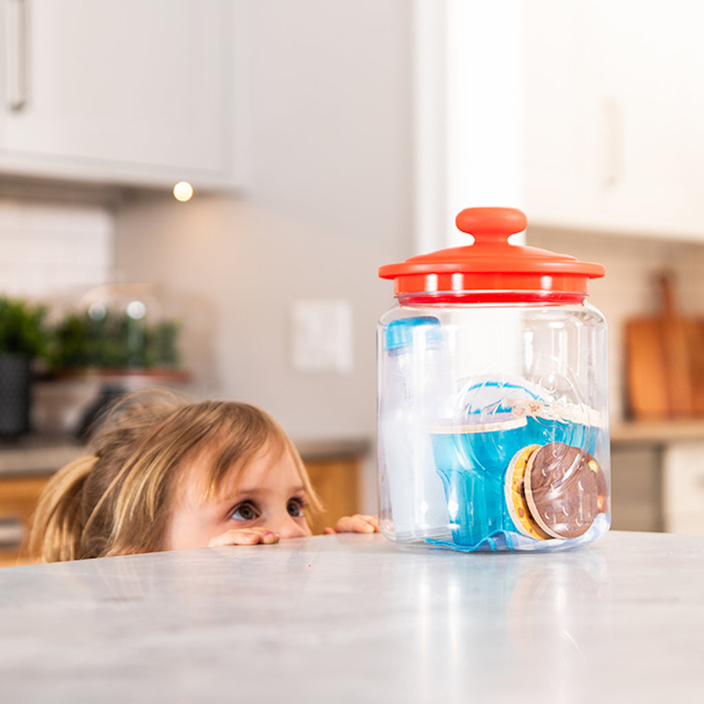 Child looking at Pretendables Milk and Cookies Set on the counter