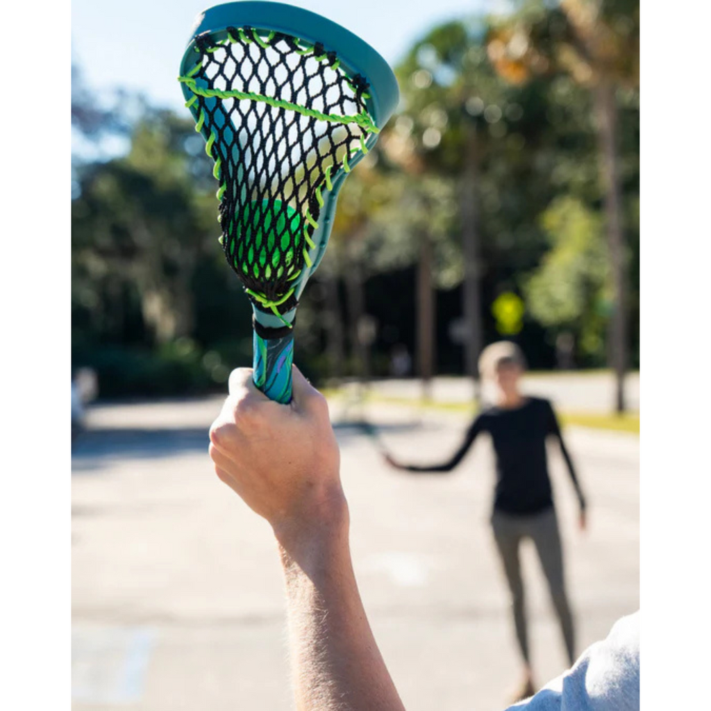 Two People Playing with Lacrosse Sticks Outside