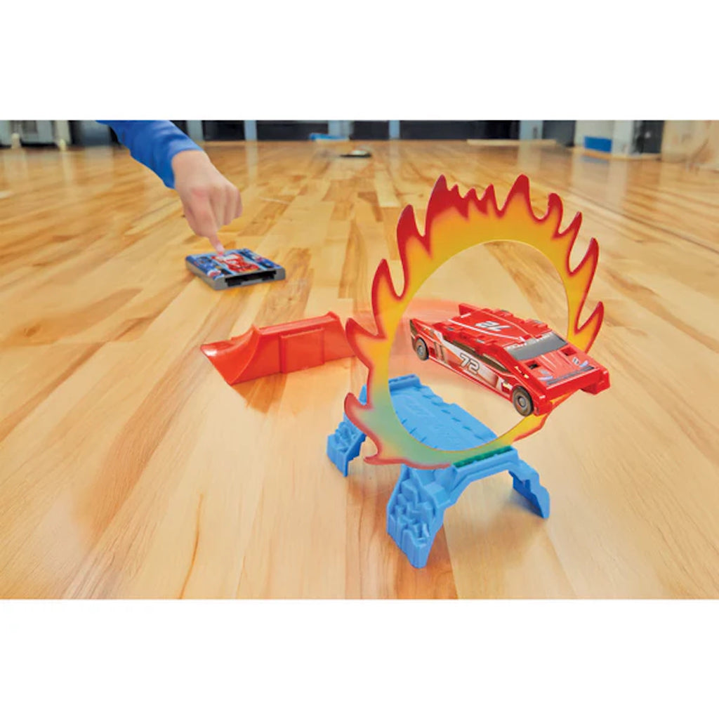 Toy car track set with a flame design on a wooden floor