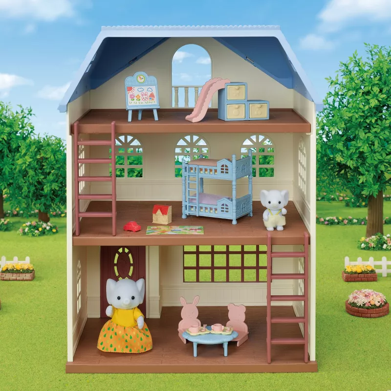 Toy dollhouse with furniture and characters on a grassy outdoor setting