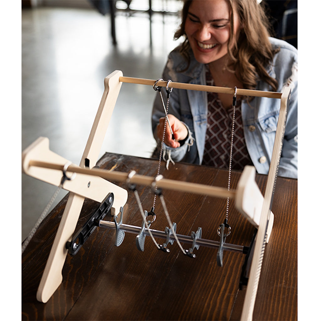 Woman sitting at a table playing Hook Rally