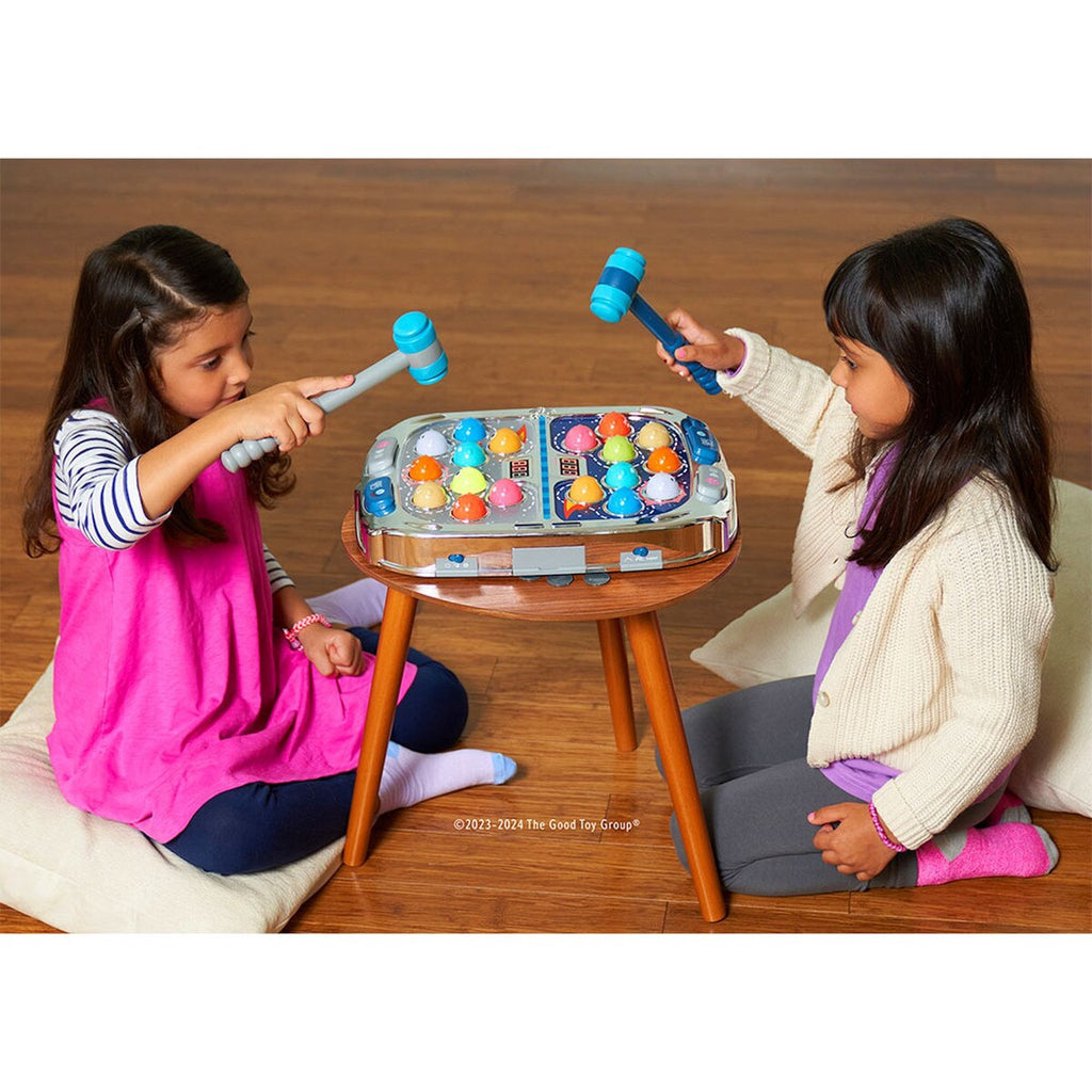 Two Children Sitting at a Table Playing with Whack Attack Space Moles