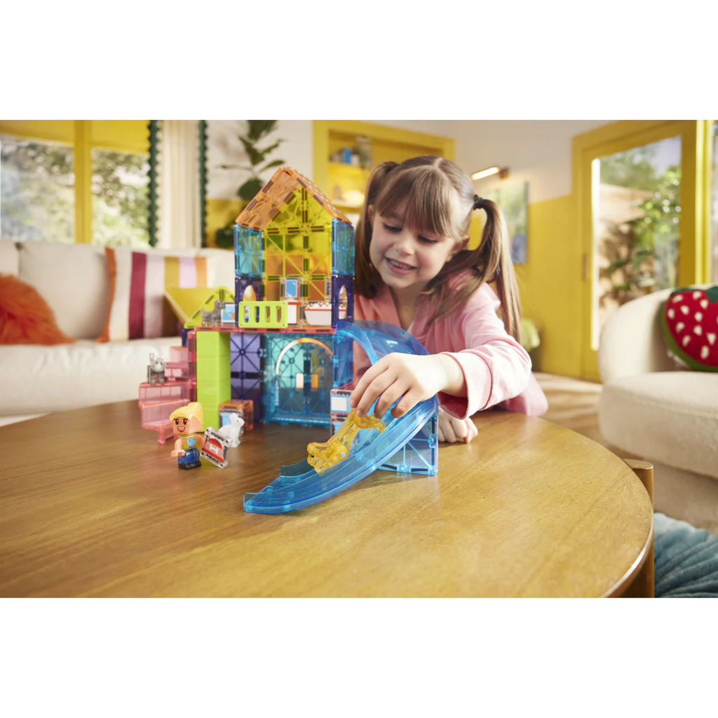 Child playing with a Magna-tiles Pet Playhouse set on a table in a living room