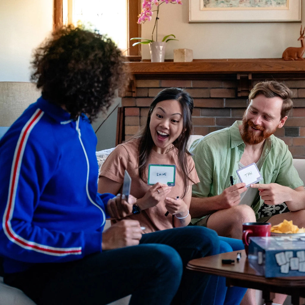 3 People playing Blank Slate in a living room on a couch