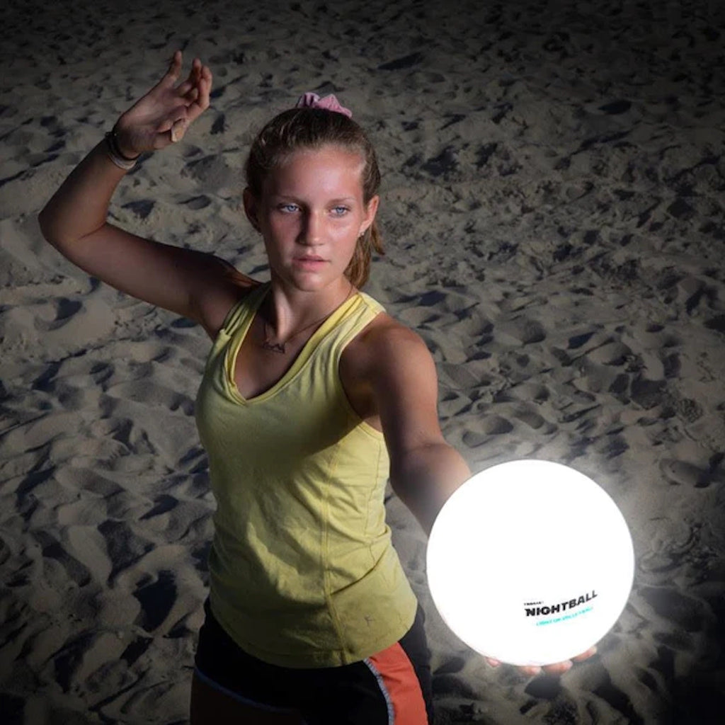 Girl playing with NightBall Volleyball lit up