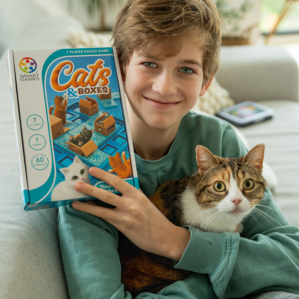 Boy holding a cat and Cats and Boxes game 