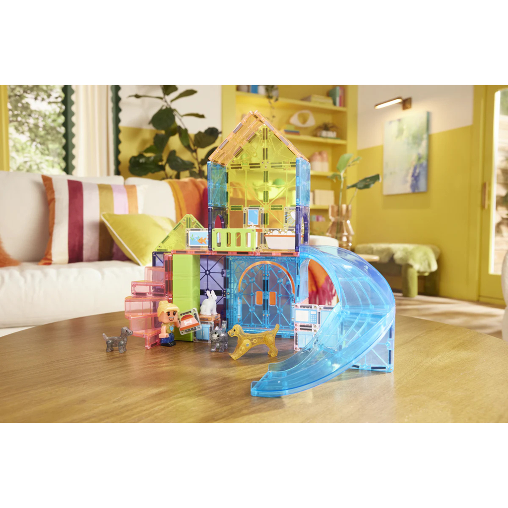 Magna-tiles Pet Playhouse with a slide on a wooden table in a living room setting