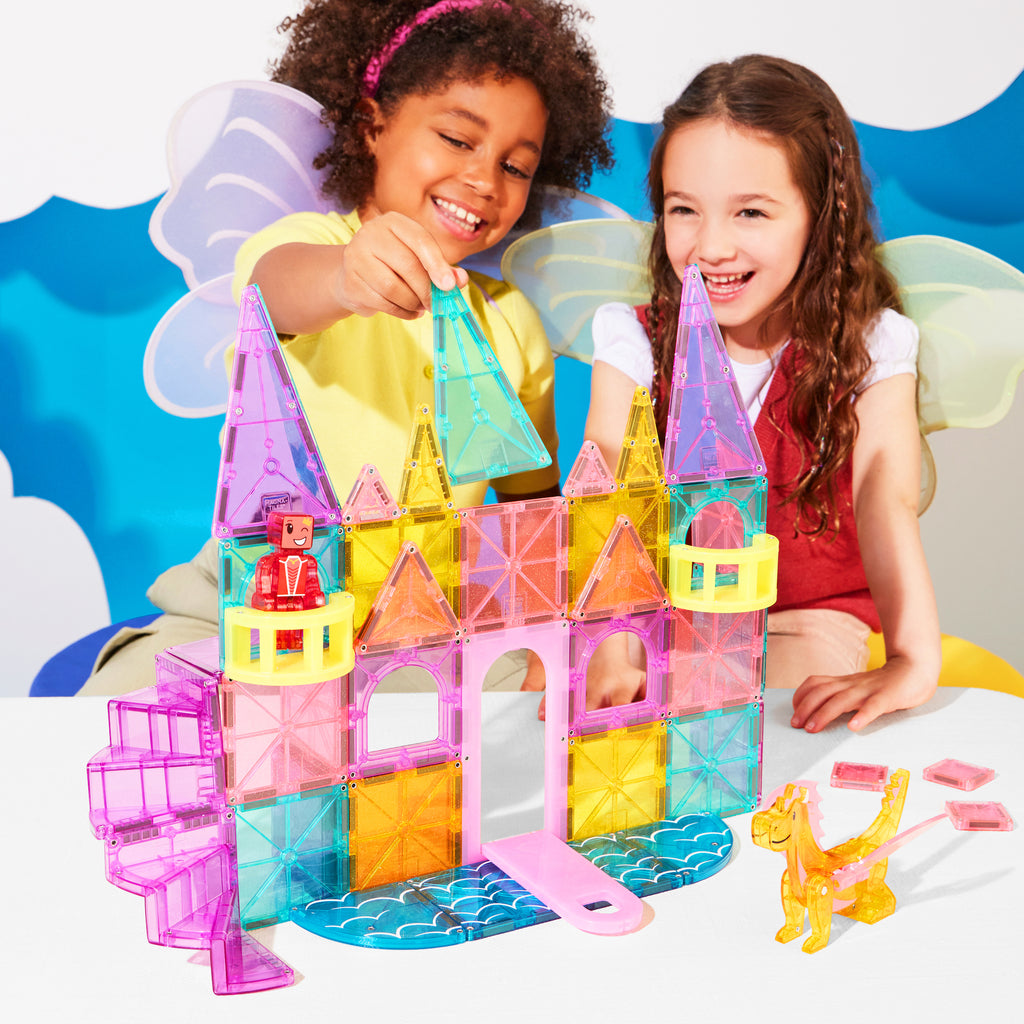 Two children wearing fairy wings playing with Magna-Tiles Castle DLX 48 Piece Set