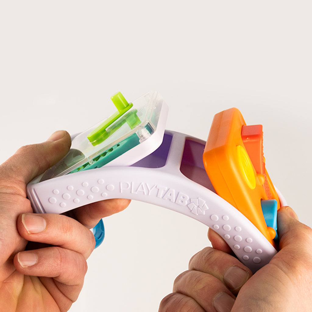 Colorful Play Tab Go held by hands against a white background