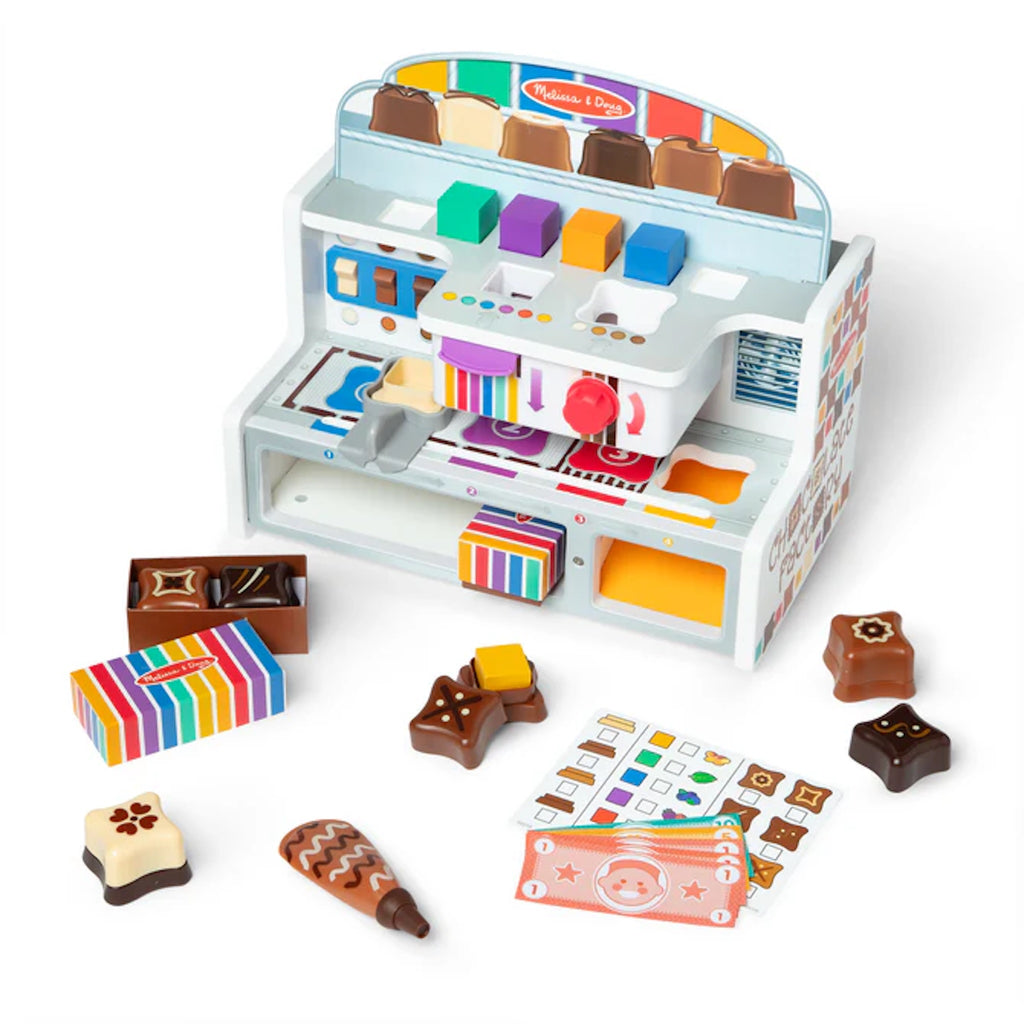 Colorful  toy Chocolate Factory with various play items on a white background