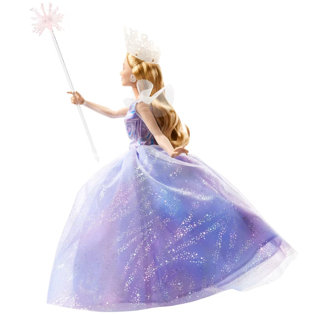 Glinda doll in a purple gown with a wand on a white background