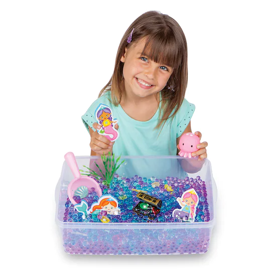 Girl Playing With Sensory Bin