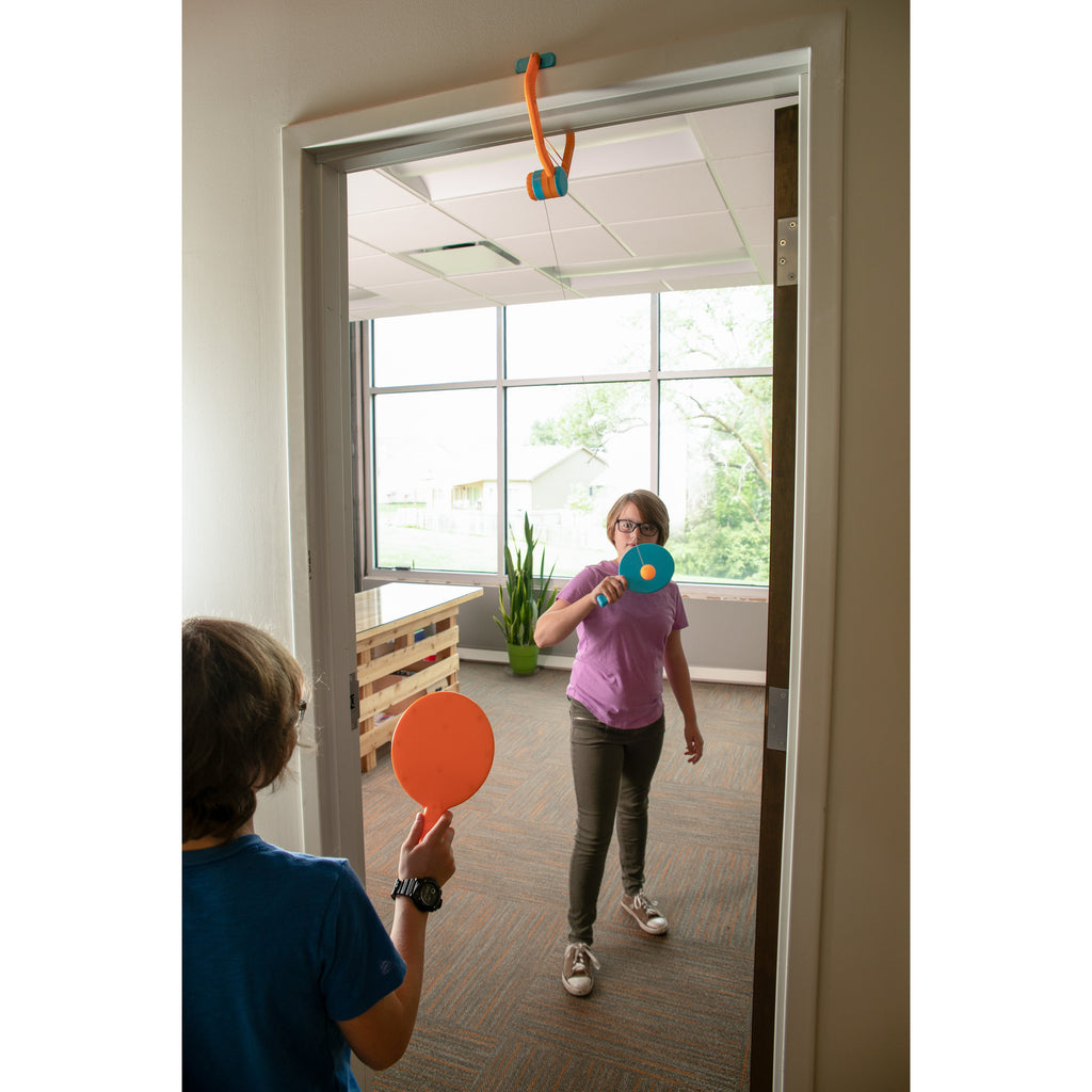 2 Children Playing Door Pong Back and Forth