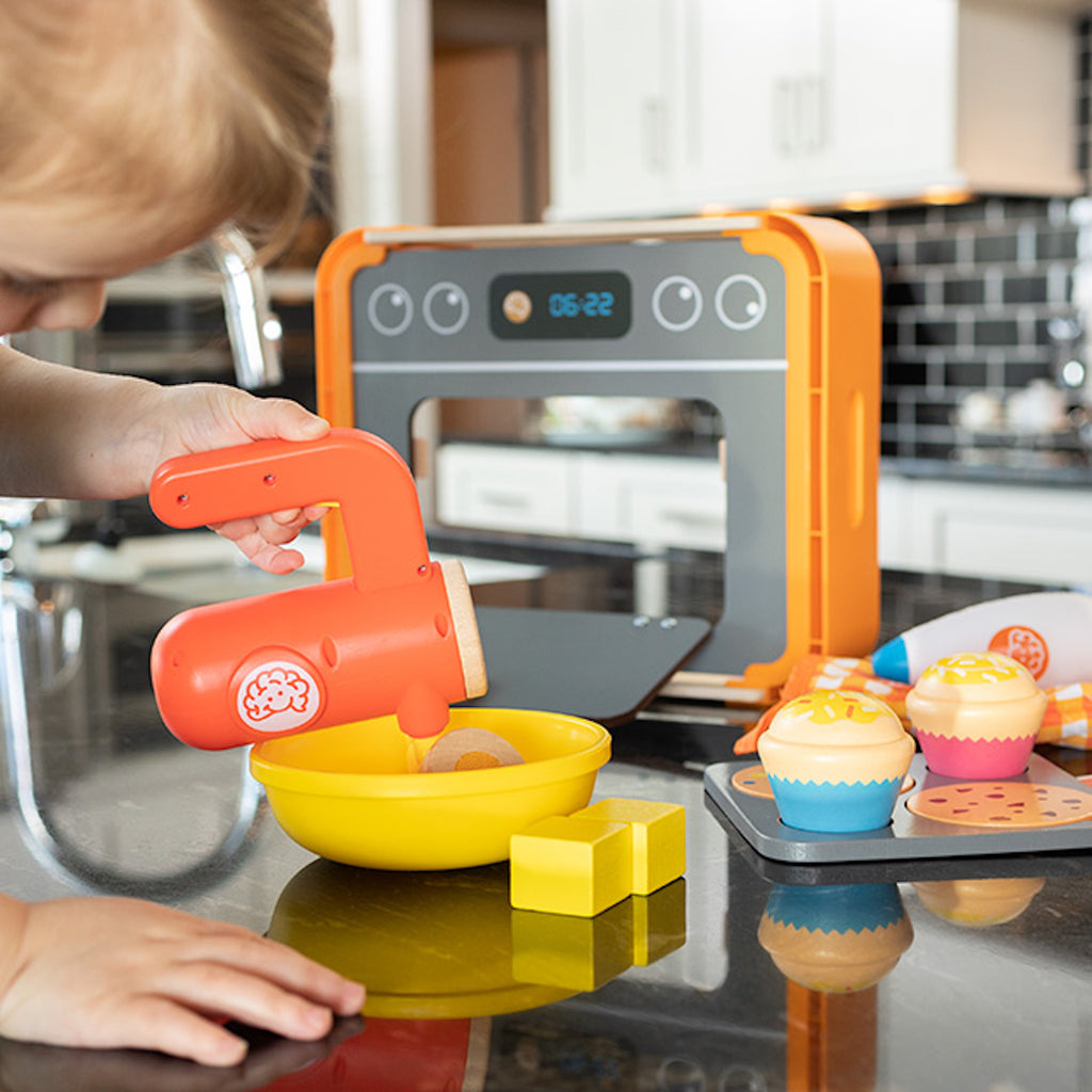 Child playing with Pretendables Bakery Set