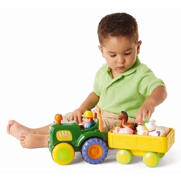 Little Boy Sitting on Floor Playing with Funtime Tractor