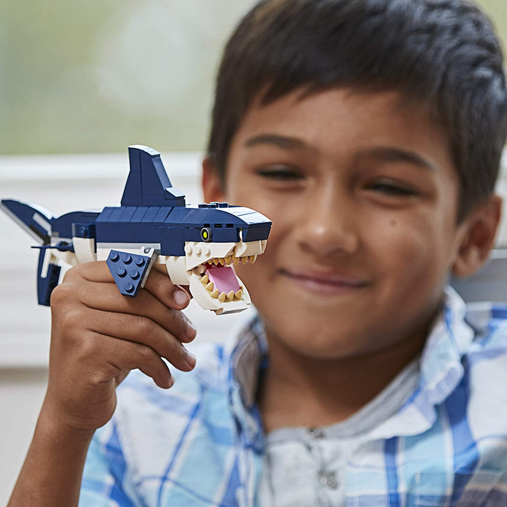 Boy Holding LEGO Shark