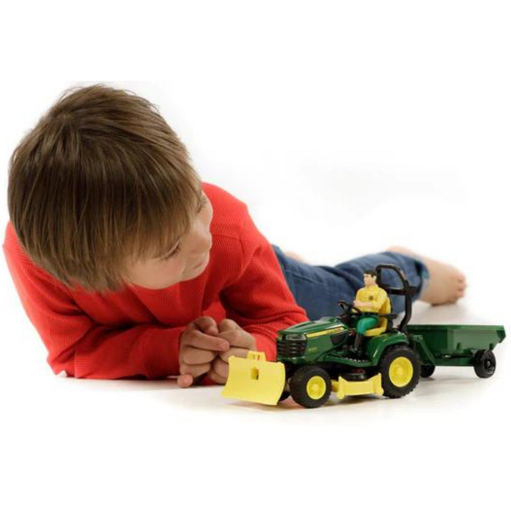 Child Playing on Floor with John Deere Lawn Tractor Trailer