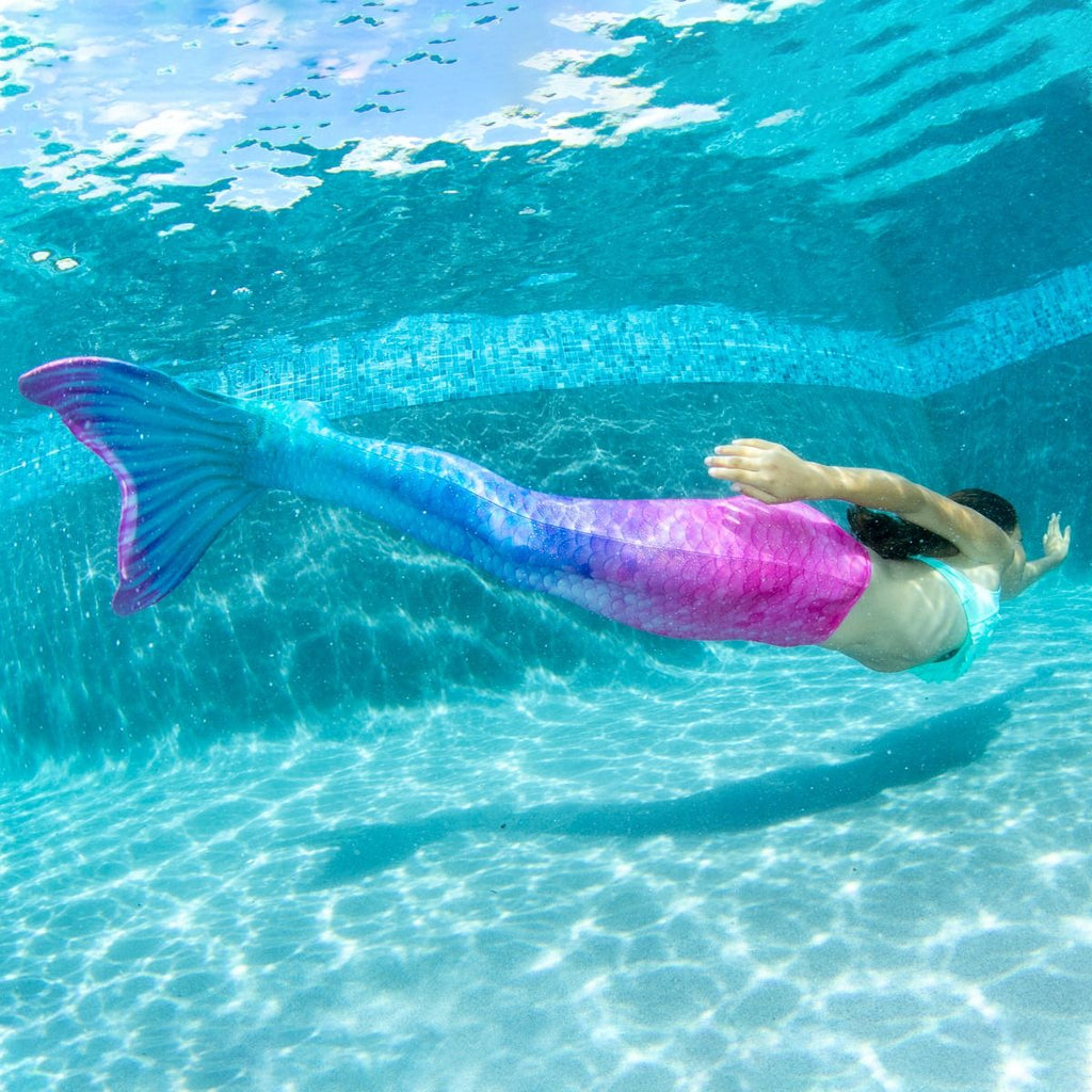 Child Wearing Fiji Fantasy Mermaid Tail Swimming in Water
