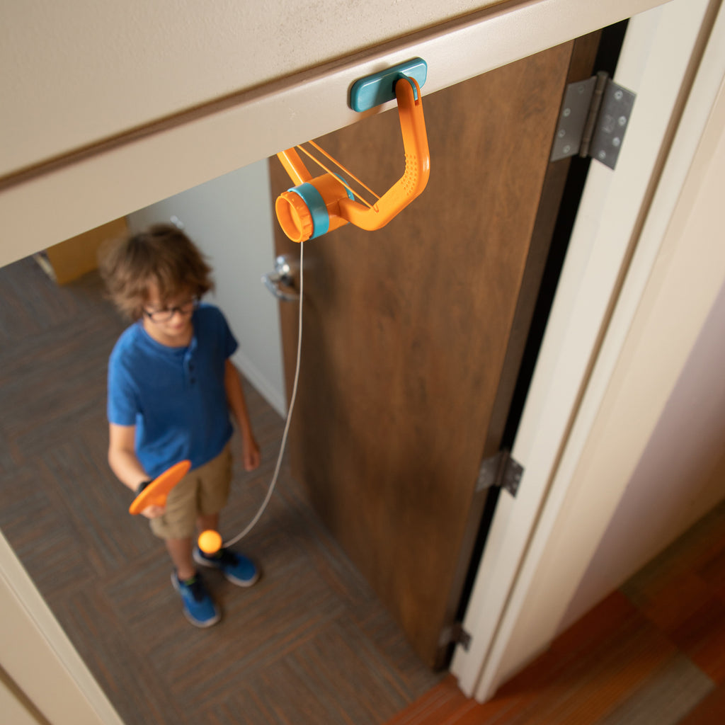 Child Playing With Door Pong on Door