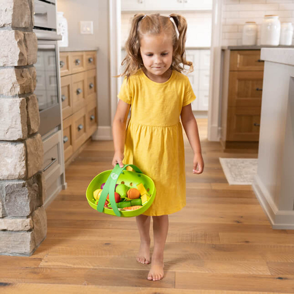 Child carrying Pretendables Fruit & Veggie Basket