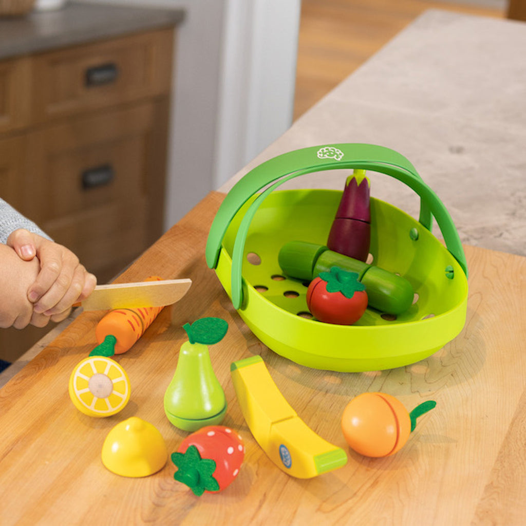 Child cutting carrot from Pretendables Fruit & Veggie Basket