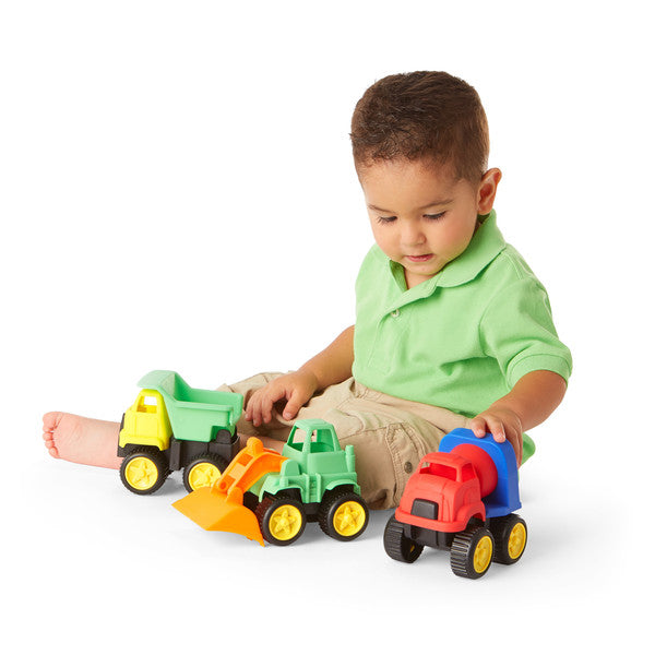 Little Boy Sitting on Floor Playing with Little Tuffies Trucks